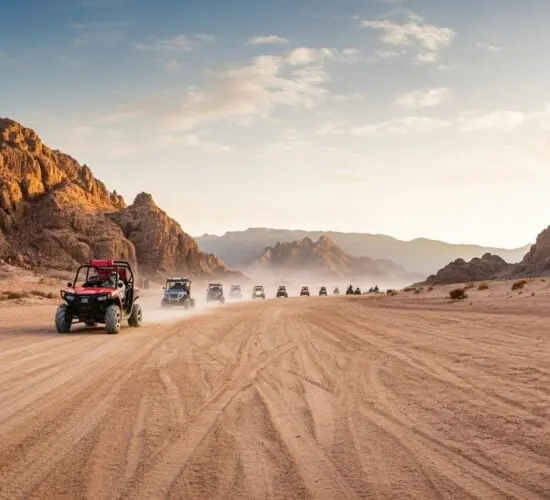 2-seater buggy speeding through Sharm El Sheikh's golden desert dunes with dramatic Sinai mountains in the background