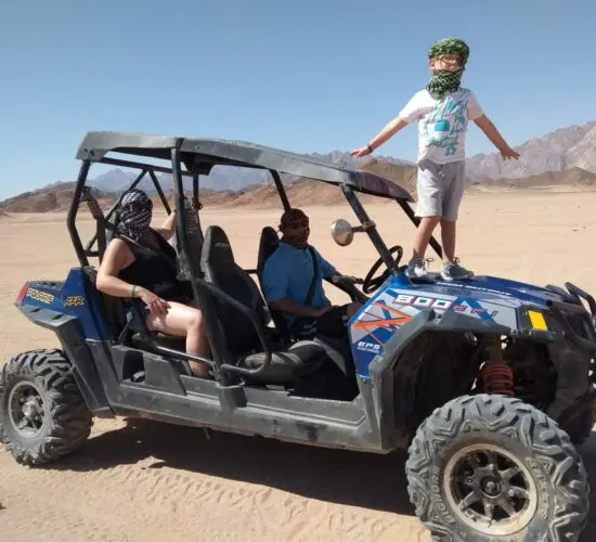 Family stopping for a photo during their safari trip in a 4 seater buggy