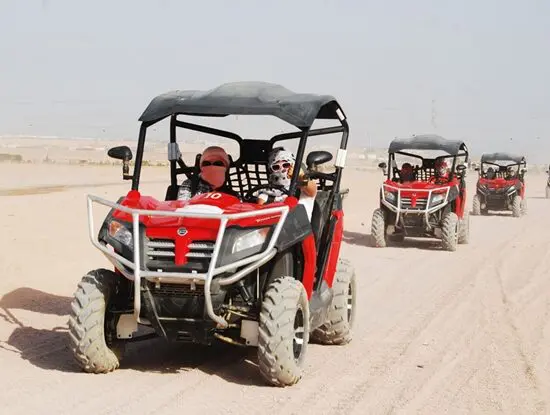 Tourists riding a double buggy in the desert