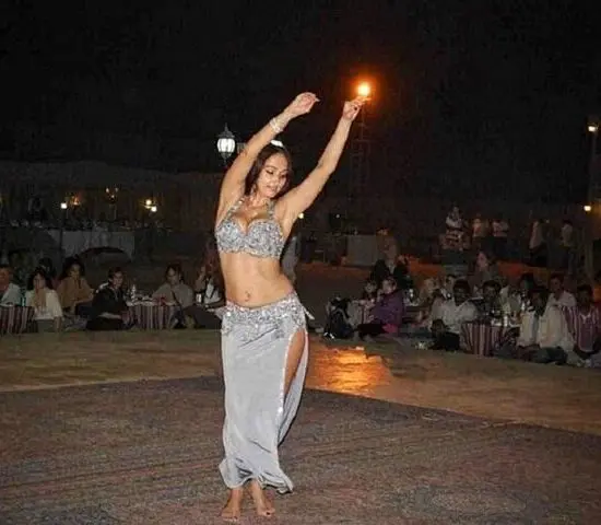 Graceful belly dancer performing under lantern lights at a traditional Bedouin dinner show during Sharm El Sheikh's super safari evening.