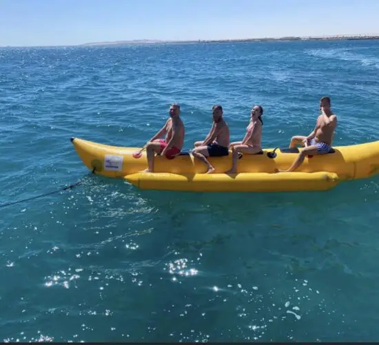 people smiling to the camera after their banana ride with sharm blue excursions