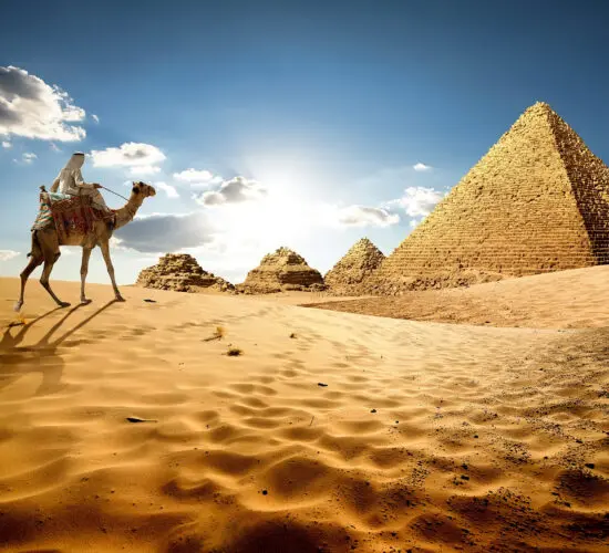 Iconic Pyramids of Giza with a camel and rider in the foreground – classic full-day Cairo excursion from Sharm El Sheikh