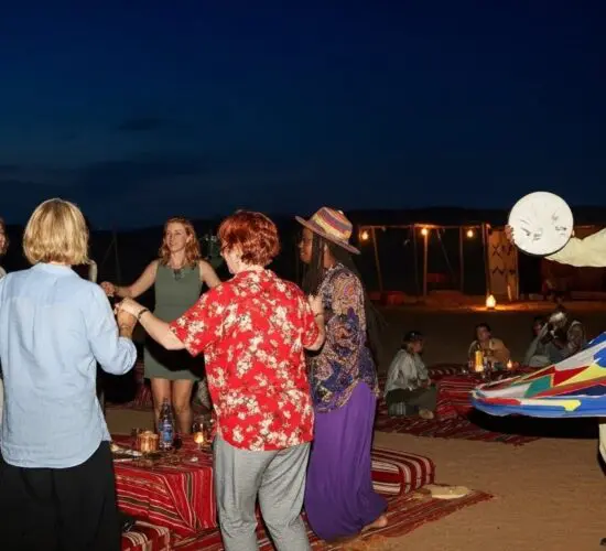 Guests enjoying traditional Bedouin barbecue dinner and live cultural show inside a decorated tent on Sharm El Sheikh super safari.